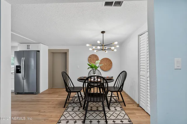 a bathroom with a granite countertop sink a mirror a bathtub and shower