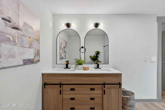 a view of a yard in front of a house with large trees