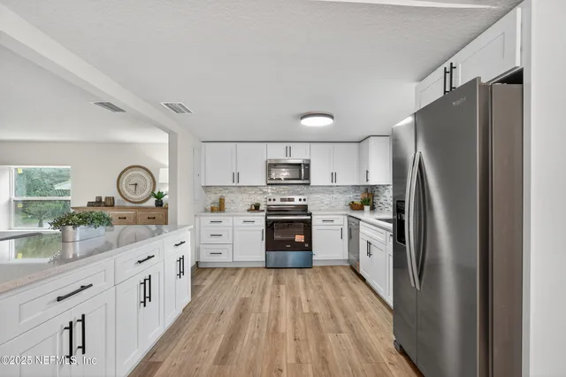 a living room with furniture a window and a table
