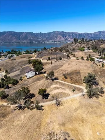 an aerial view of a house and mountain view