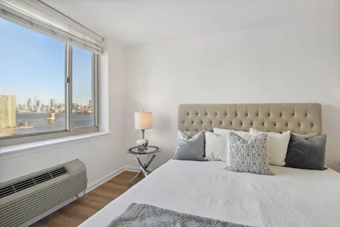 a bedroom with a large bed and a couch