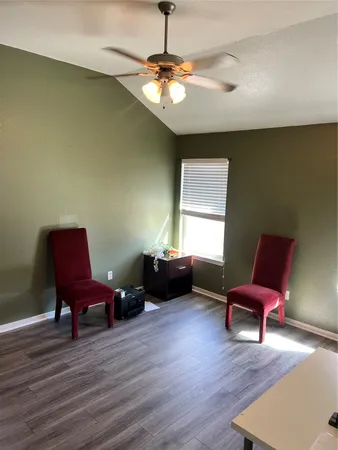 a living room with furniture and a chair