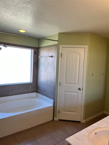 a bathroom with a tub and shower