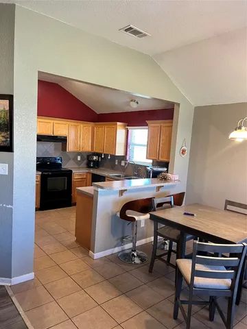 a kitchen with a sink cabinets and window