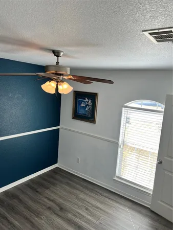 a view of a room with a window and wooden floor