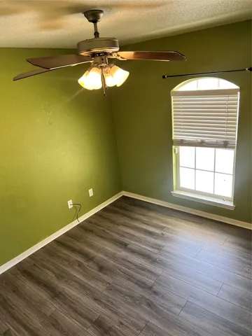 a view of a room with wooden floor and windows
