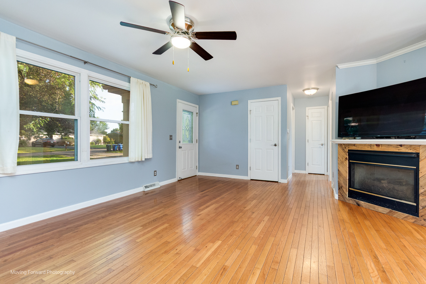 1907 Irene Road Sandwich, IL 60548 - Photo 4 of 25 a view of empty room with wooden floor fireplace and a window