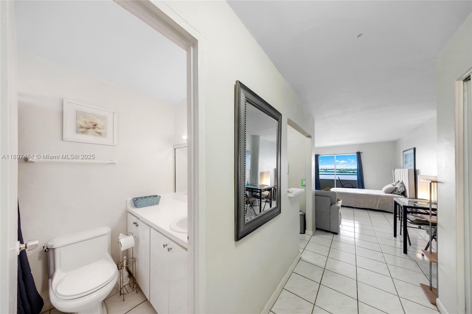 7904 West Drive, Unit 1010 North Bay Village, FL 33141 - Photo 13 of 25 a living room with furniture a rug a toilet and a sink