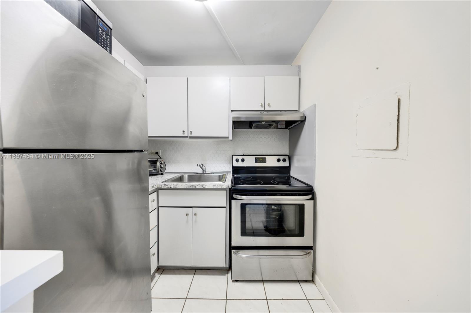 7904 West Drive, Unit 1010 North Bay Village, FL 33141 - Photo 17 of 25 a kitchen with stainless steel appliances a stove a refrigerator and a sink