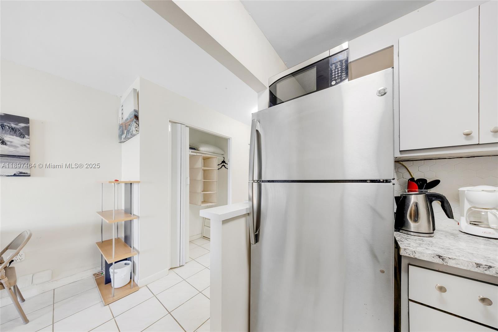 7904 West Drive, Unit 1010 North Bay Village, FL 33141 - Photo 18 of 25 a white refrigerator freezer and a stove sitting inside of a kitchen