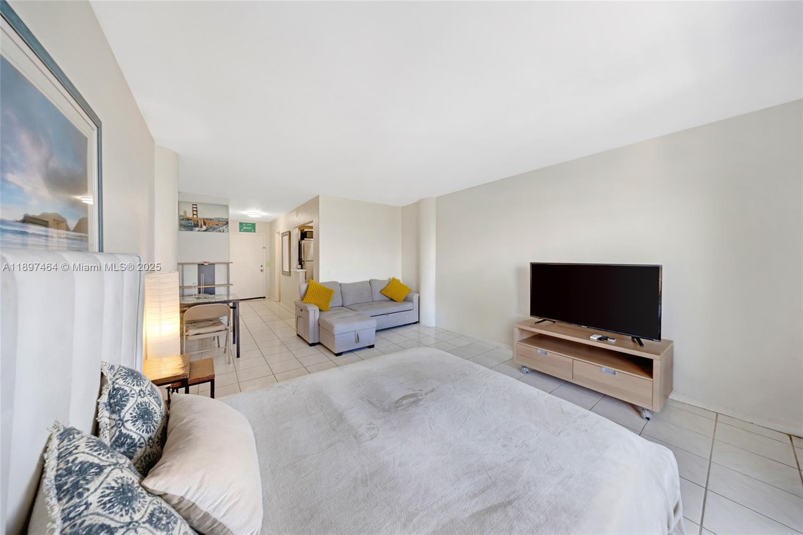 7904 West Drive, Unit 1010 North Bay Village, FL 33141 - Photo 3 of 25 a bedroom with a bed and a flat screen tv