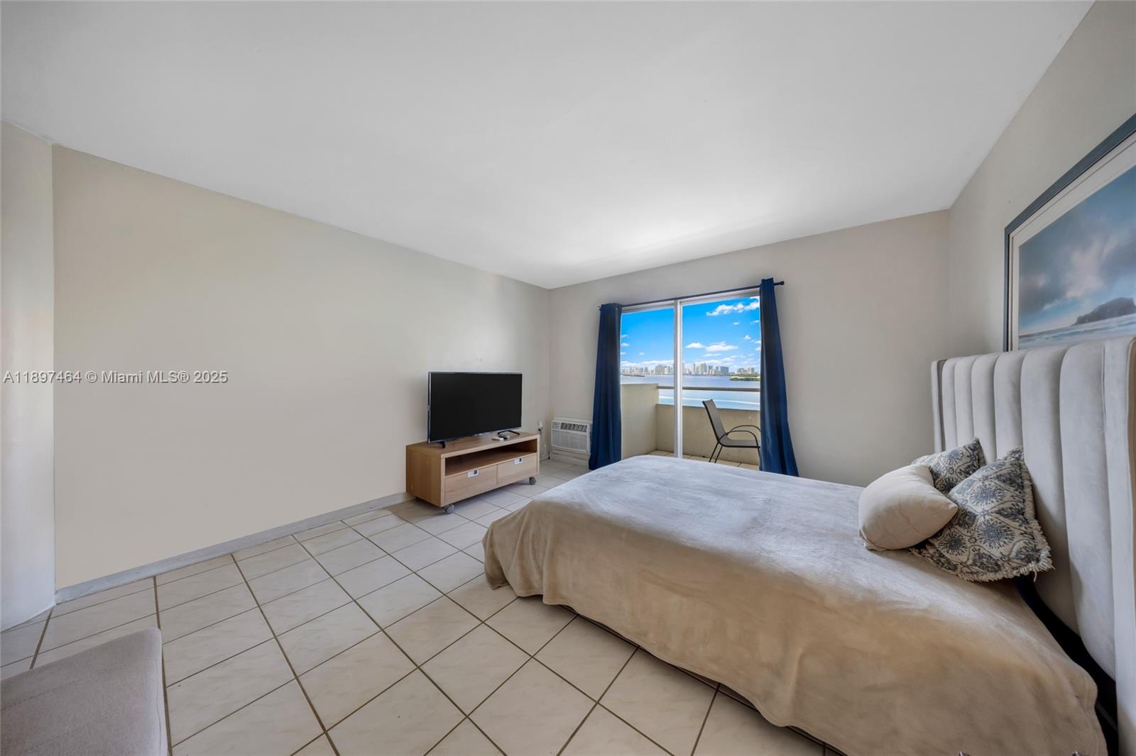 7904 West Drive, Unit 1010 North Bay Village, FL 33141 - Photo 5 of 25 a bedroom with a bed and furniture