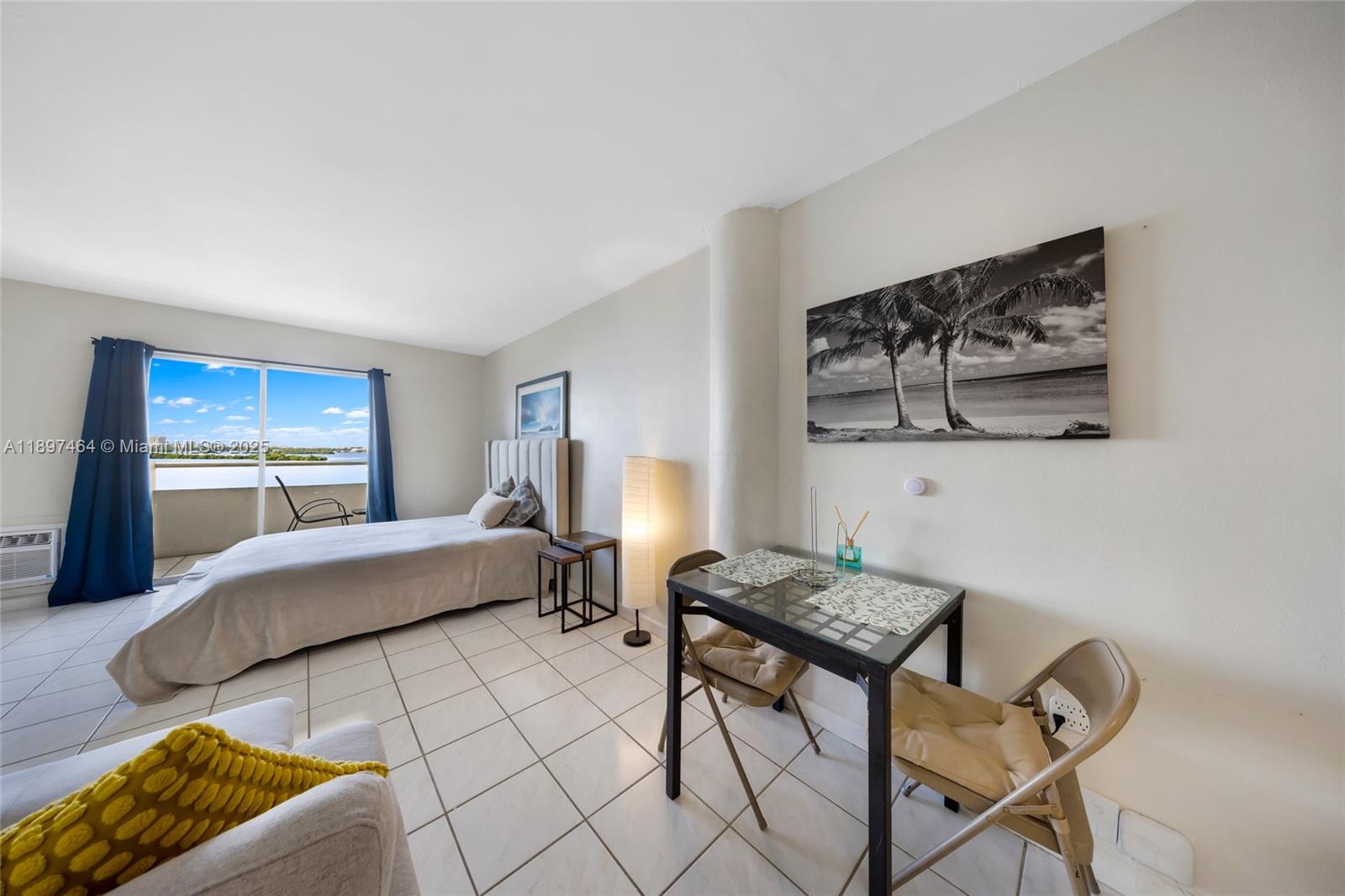 7904 West Drive, Unit 1010 North Bay Village, FL 33141 - Photo 7 of 25 a bedroom with a bed and a view of kitchen