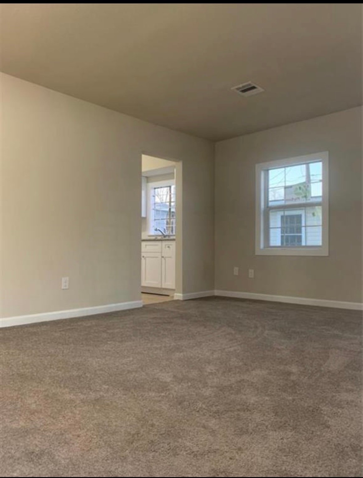 324 Delaware Street, Unit B Houston, TX 77029 - Photo 2 of 15 an empty room with windows