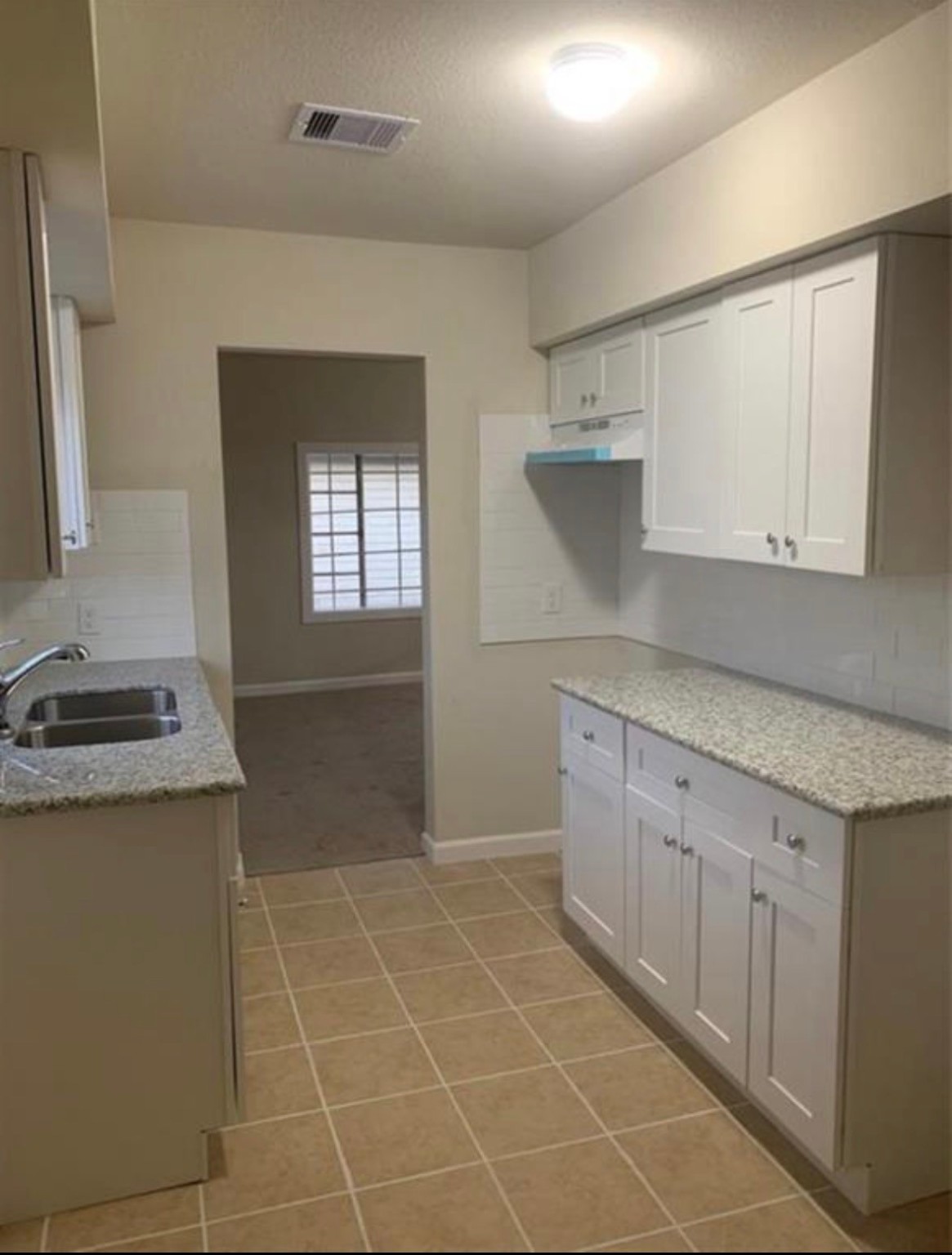 324 Delaware Street, Unit B Houston, TX 77029 - Photo 5 of 15 a kitchen with a sink a stove and cabinets