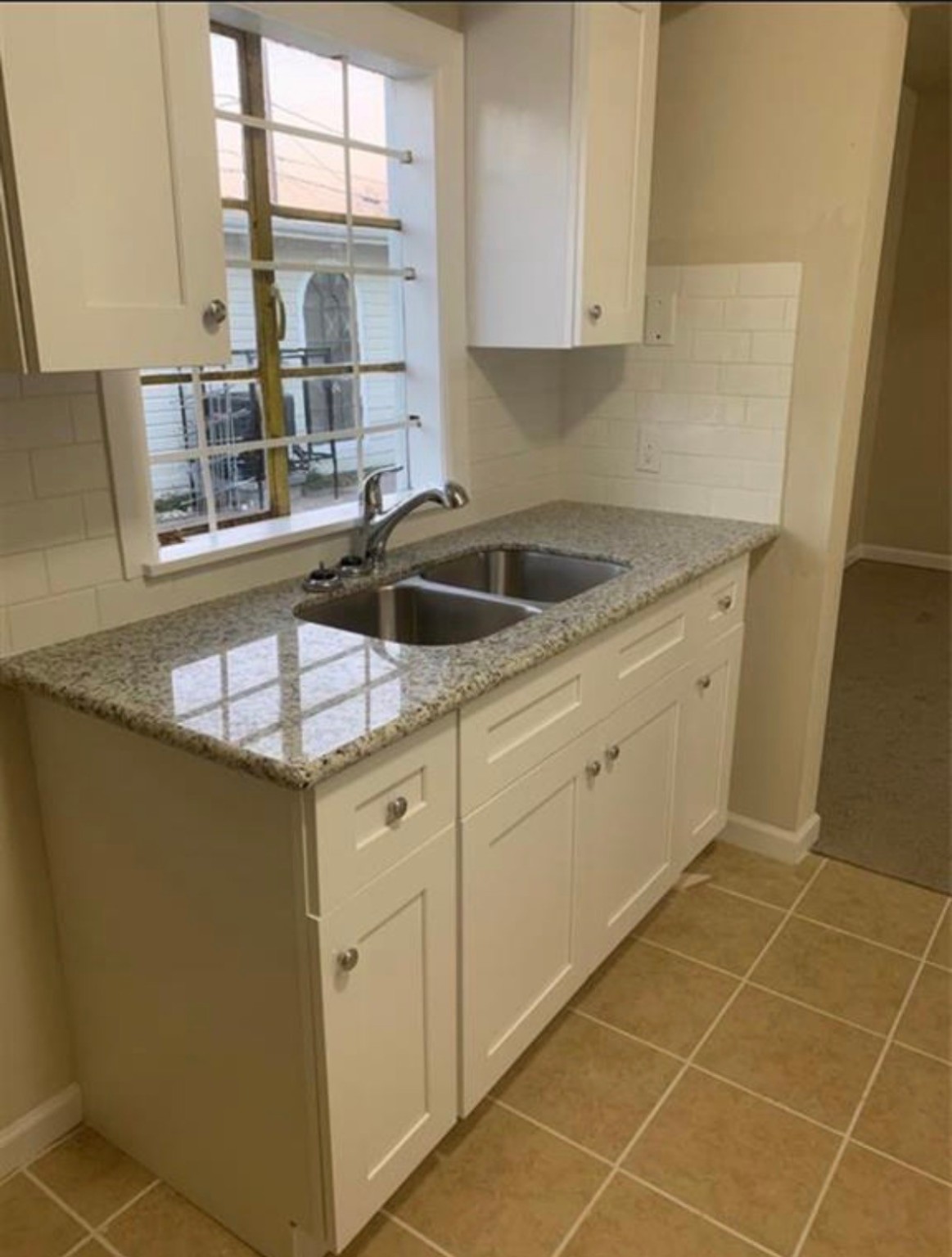 324 Delaware Street, Unit B Houston, TX 77029 - Photo 6 of 15 a kitchen with a sink cabinets and window