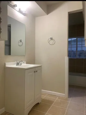 a bathroom with a sink a toilet and a shower