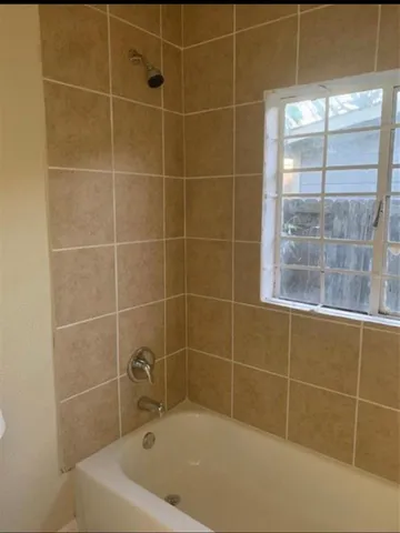 a bath tub sitting next to a window