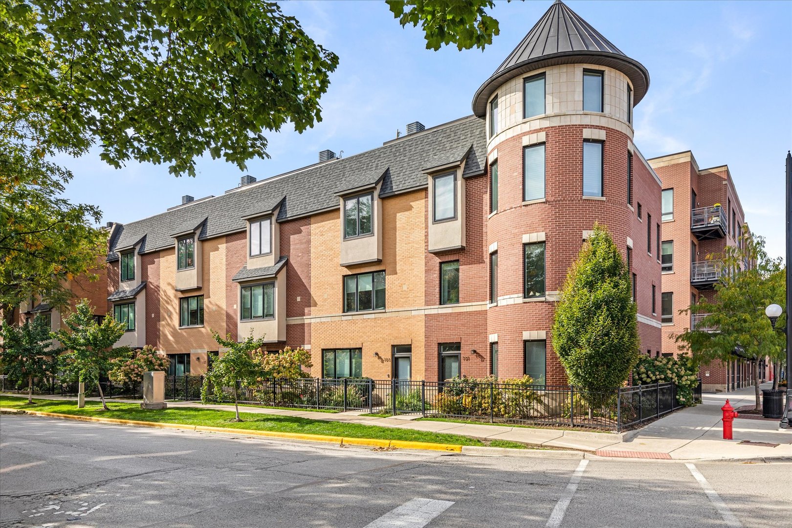 a front view of a residential apartment building with a yard