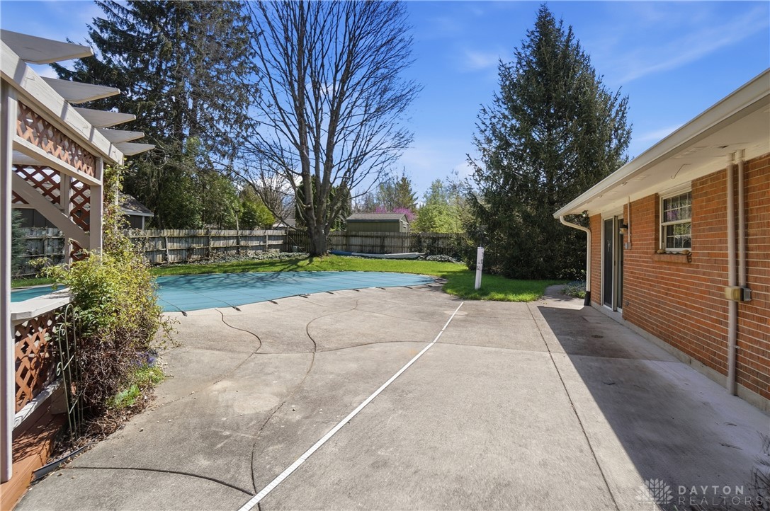 9964 Hummingbird Way Dayton, OH 45458 - Photo 55 of 57 This spacious backyard features a covered pool and ample patio space for outdoor enjoyment.