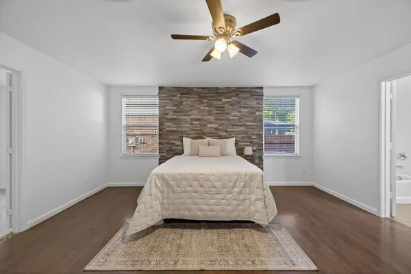 a bedroom with a large bed and a window