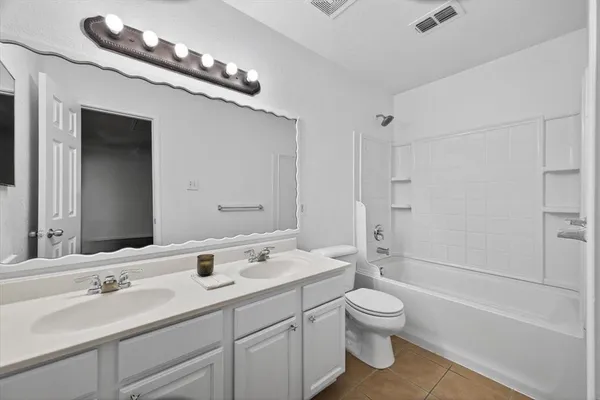 a view of a big room with wooden floor and a ceiling fan