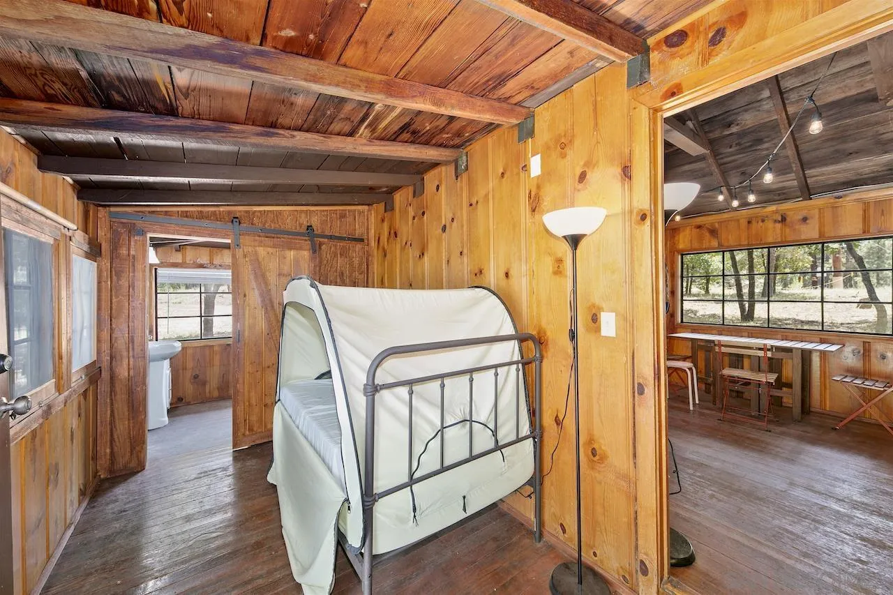 509 El Centro Terrace Mount Laguna, CA 91948 - Photo 15 of 23 a bedroom with a bed and wooden floor