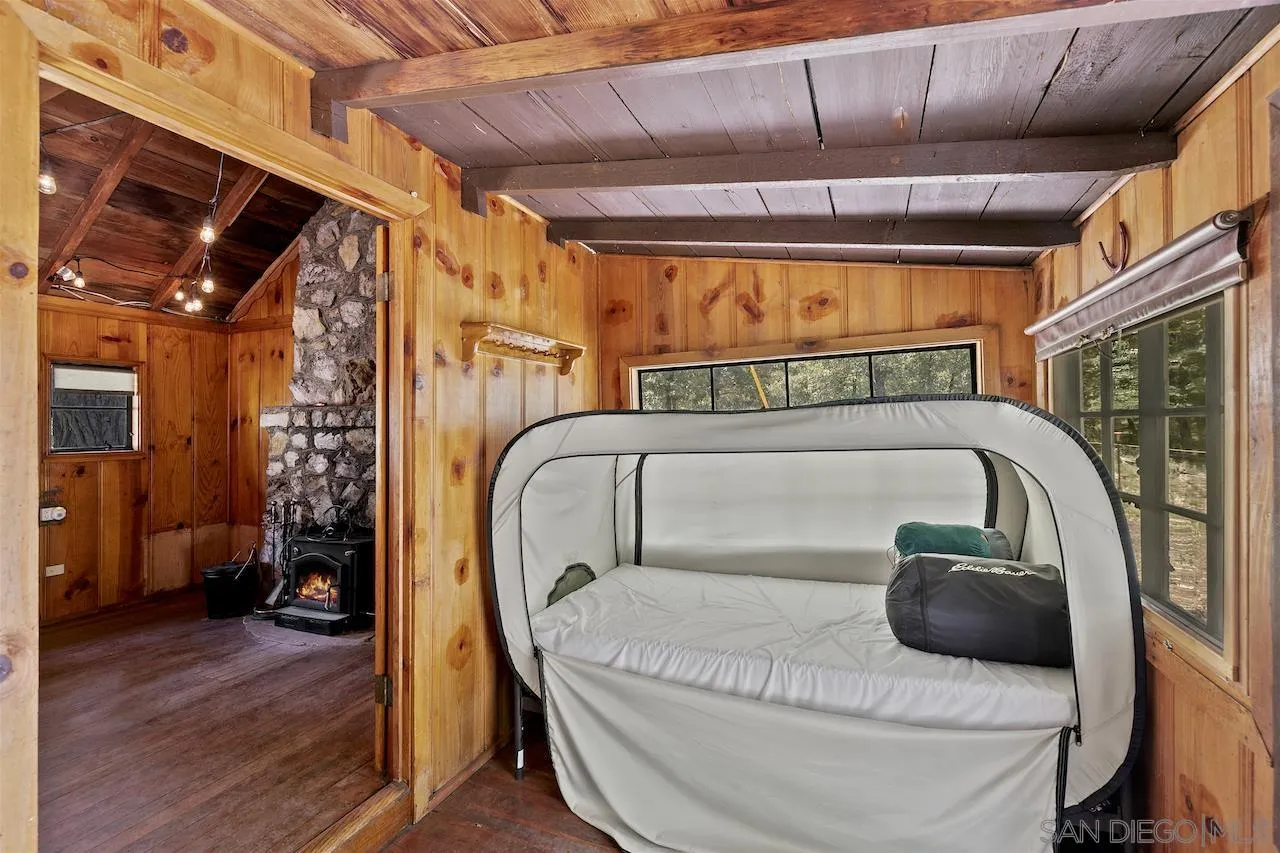 509 El Centro Terrace Mount Laguna, CA 91948 - Photo 16 of 23 a bedroom with a bed and a mirror