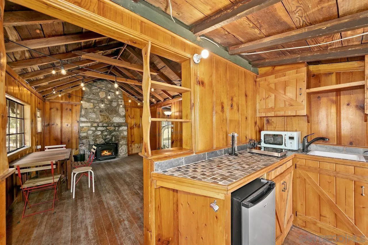 509 El Centro Terrace Mount Laguna, CA 91948 - Photo 7 of 23 a kitchen that has a stove and a table