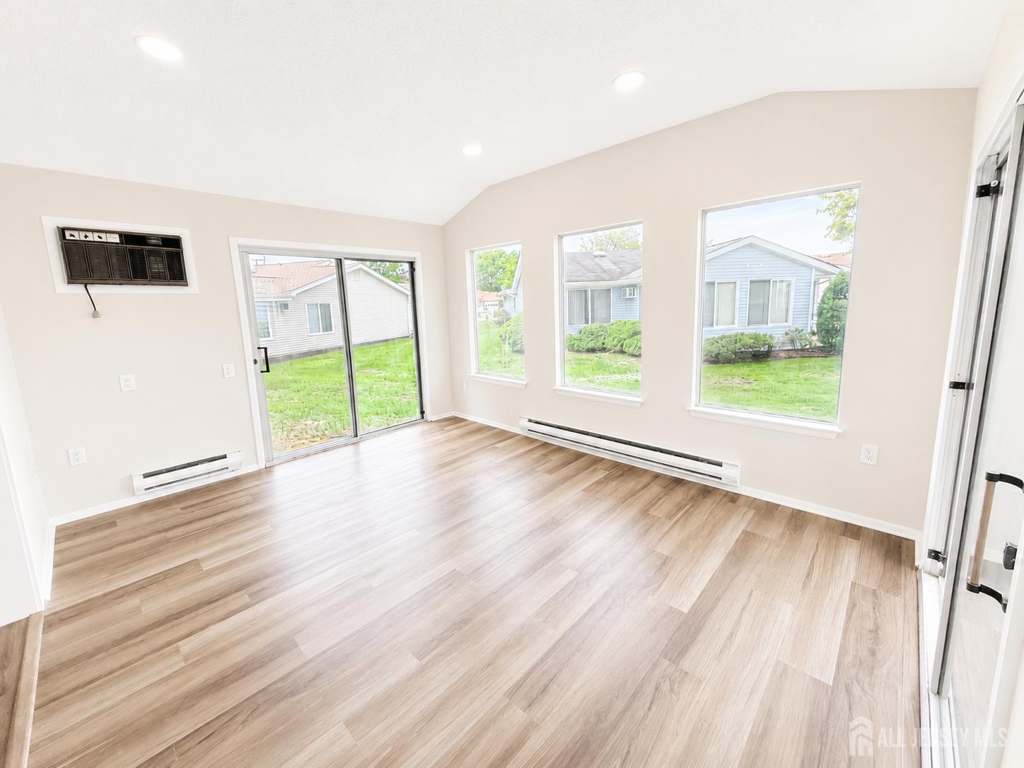 621 A Deal Road Monroe Township, NJ 08831 - Photo 11 of 27 a view of an empty room with a window and wooden floor