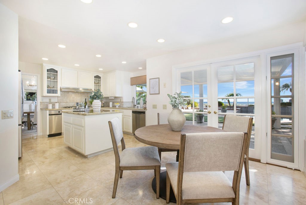 22 Callender Court Laguna Niguel, CA 92677 - Photo 16 of 67 a dining room with kitchen island a table and chairs