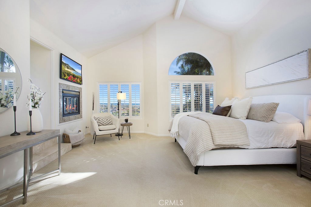 22 Callender Court Laguna Niguel, CA 92677 - Photo 29 of 67 a spacious bedroom with a bed a couch and a large window