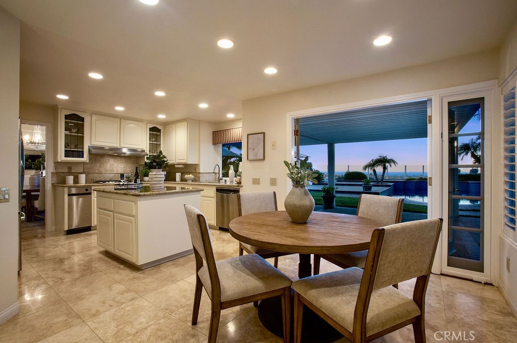 22 Callender Court Laguna Niguel, CA 92677 - Photo 49 of 67 a kitchen with a dining table chairs and refrigerator