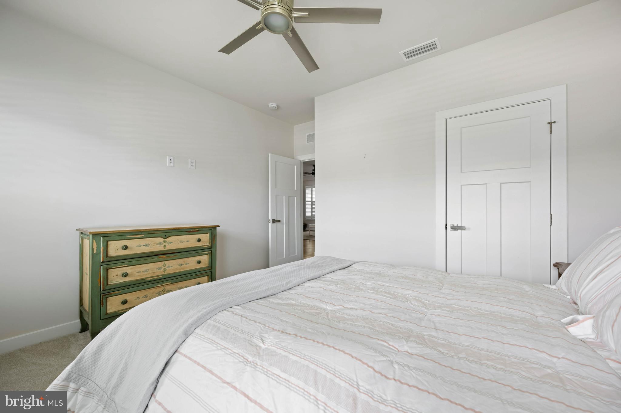 37689 Wildwood Lane Dagsboro, DE 19939 - Photo 28 of 43 a bedroom with a bed and a chandelier