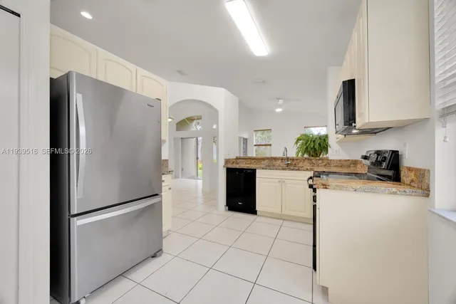 a kitchen with a refrigerator a sink and a stove