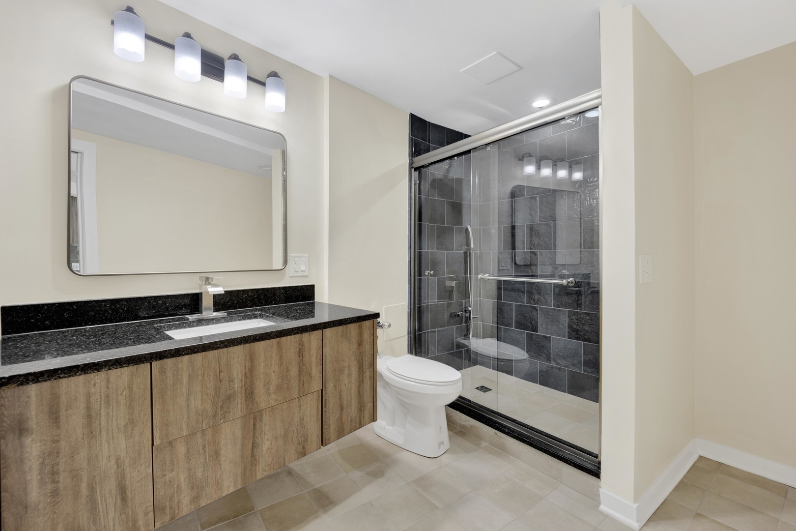 300 North State Street, Unit 4512 Chicago, IL 60654 - Photo 11 of 21 a bathroom with a granite countertop sink mirror and toilet