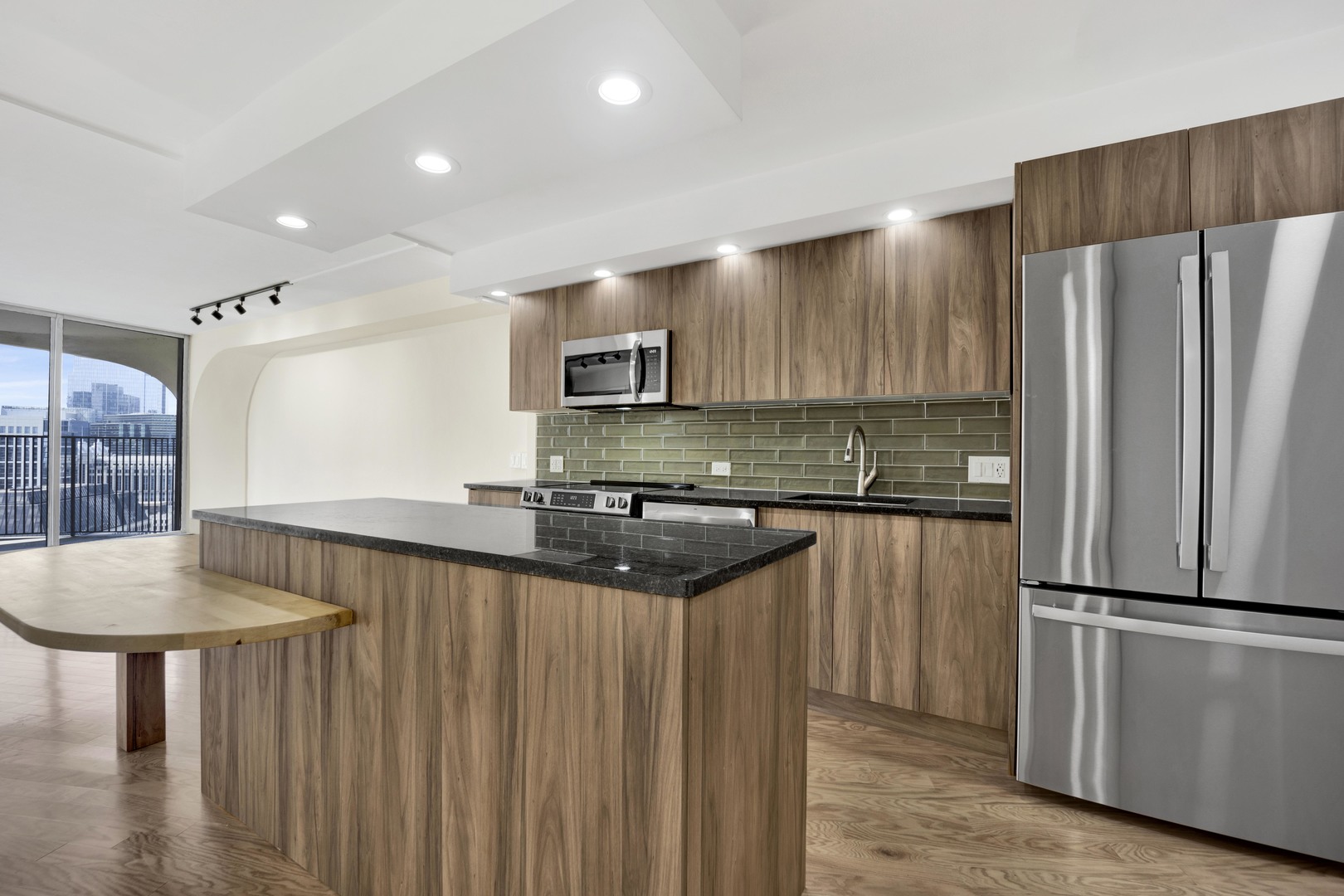 300 North State Street, Unit 4512 Chicago, IL 60654 - Photo 4 of 21 a kitchen with stainless steel appliances granite countertop a refrigerator a stove and a sink with wooden cabinets