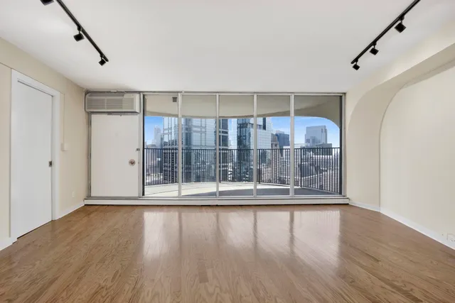 a view of wooden floor and brick walls