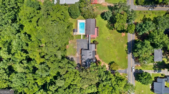 an aerial view of a house with a yard and garden