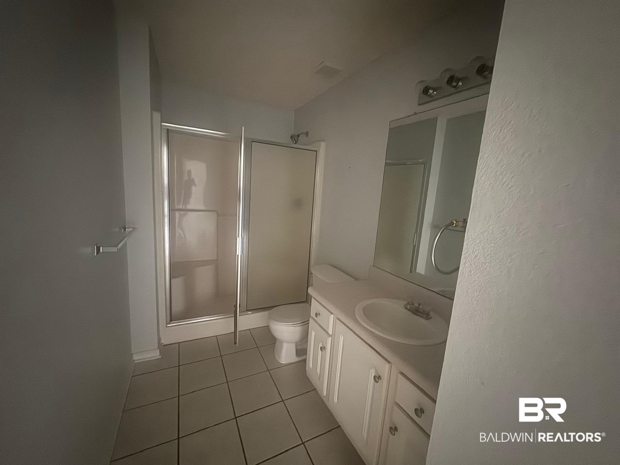 101 Monteith Circle Foley, AL 36535 - Photo 13 of 28 Bathroom featuring a shower stall, vanity, and light tile patterned flooring