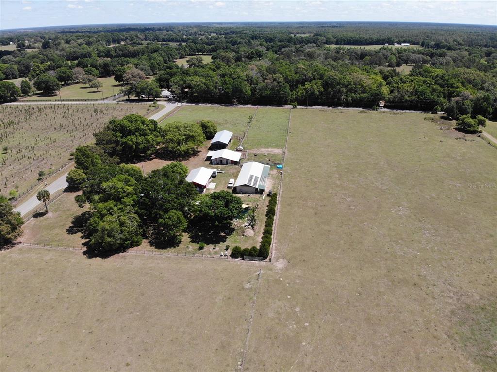 3650 Northeast 95th Street Anthony, FL 32617 - Photo 2 of 7 an aerial view of a house with a yard and lake view