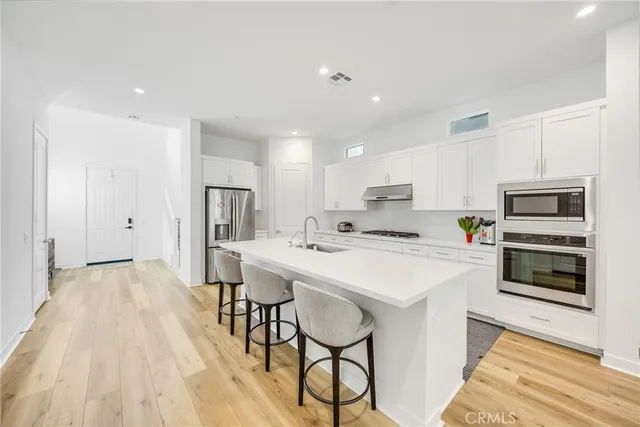a kitchen with a sink a microwave and refrigerator