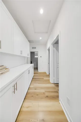 a view of a kitchen with sink and a refrigerator