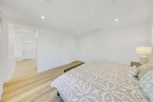 a bedroom with a bed and a lamp
