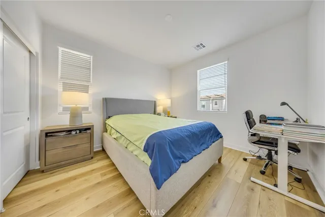 a spacious bedroom with a bed and a desk