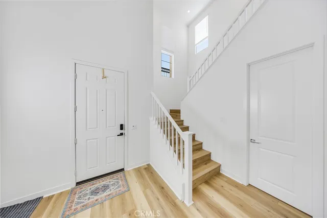 a view of entryway with stairs and wooden floor