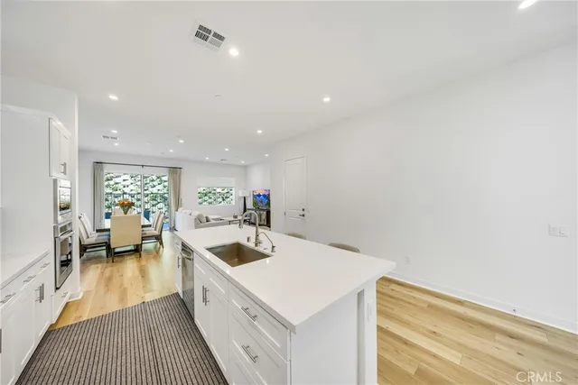a kitchen with a sink a stove and a refrigerator