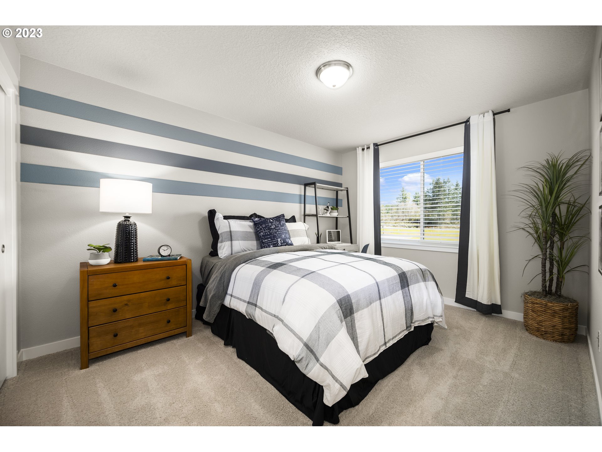 8836 North 3rd Circle Ridgefield, WA 98642 - Photo 29 of 32 a spacious bedroom with a bed and a large window