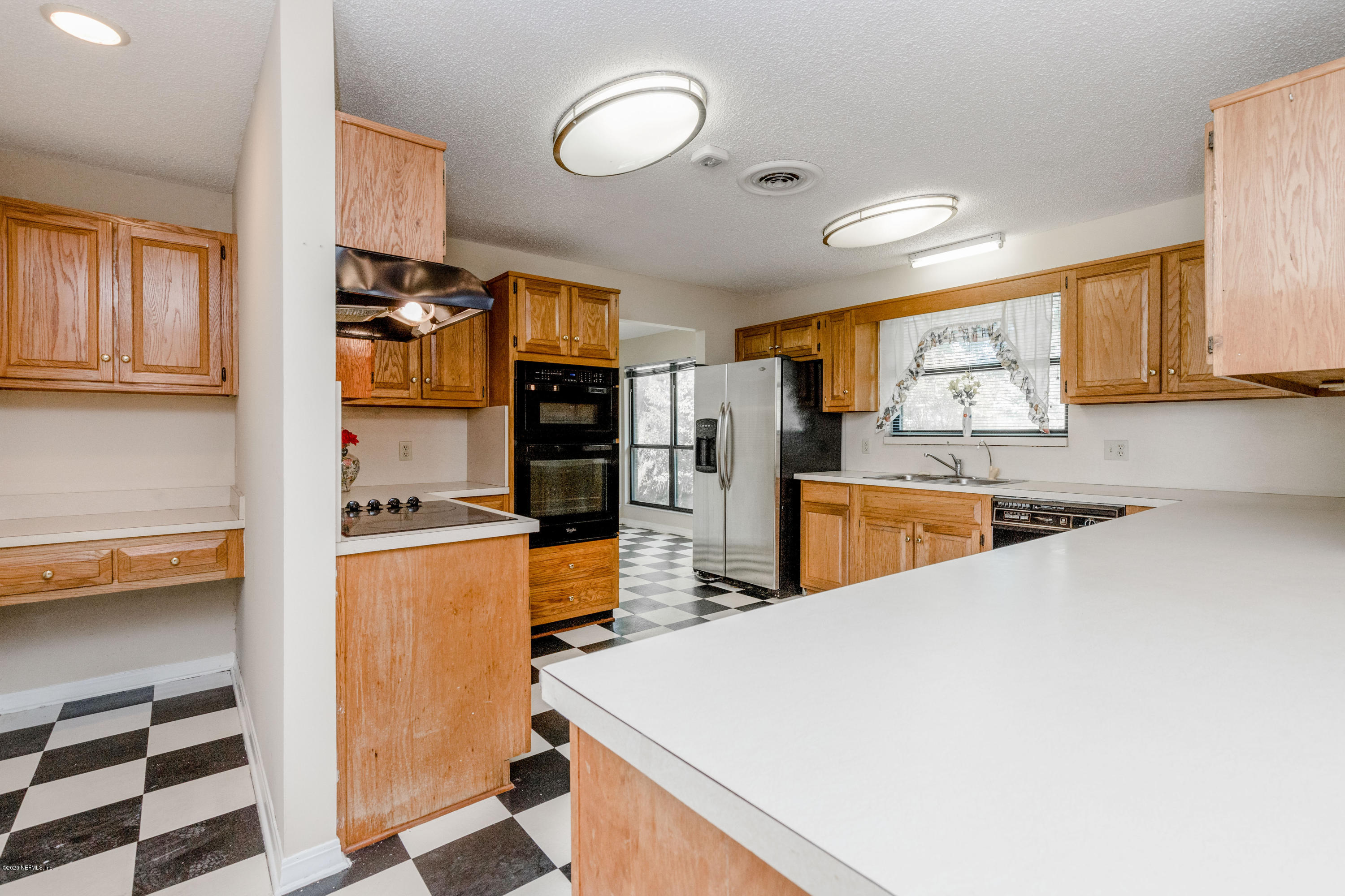 1704 Memory Lane Jacksonville, FL 32210 - Photo 11 of 54 a kitchen with stainless steel appliances a refrigerator sink and cabinets