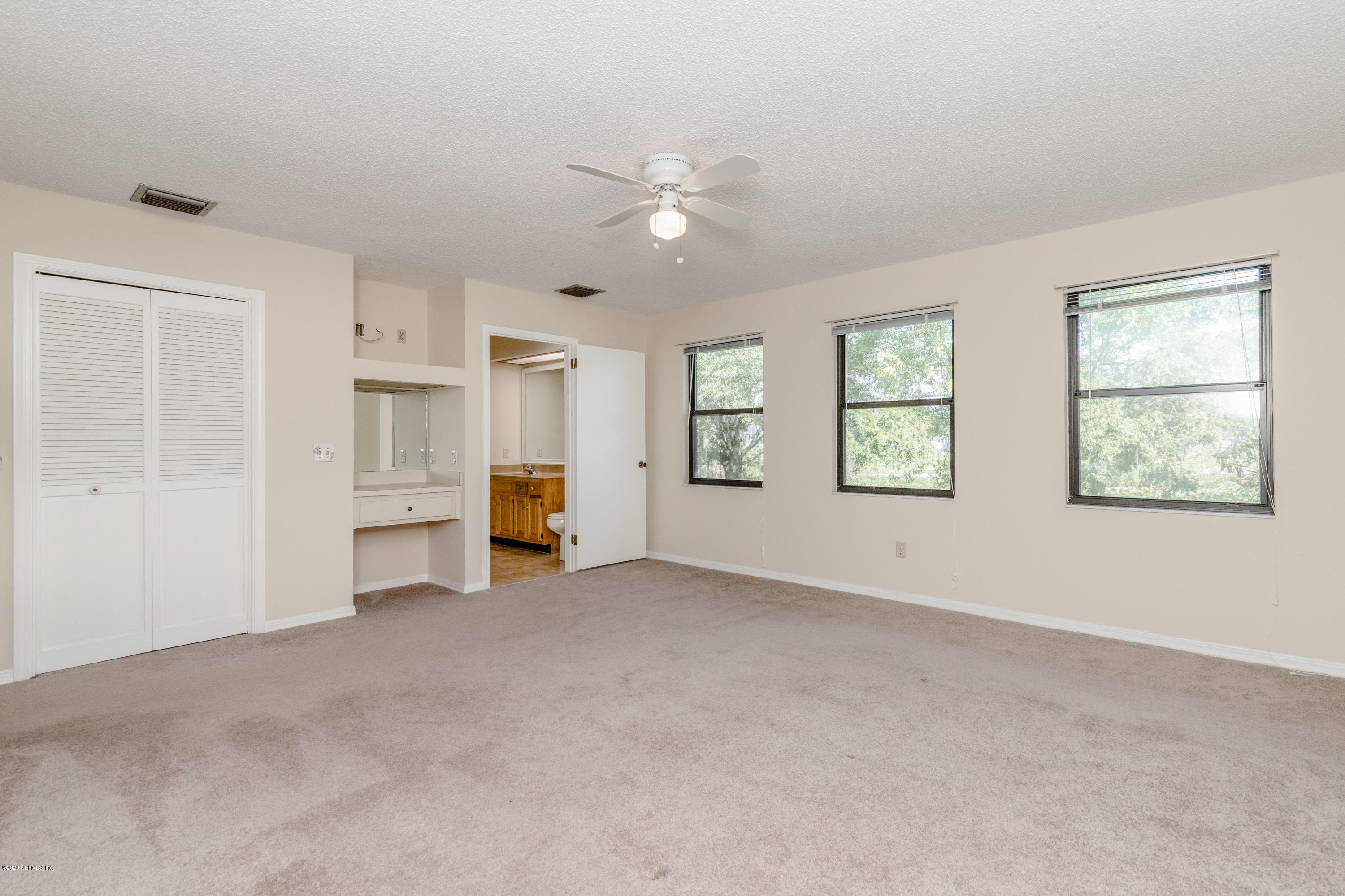 1704 Memory Lane Jacksonville, FL 32210 - Photo 15 of 54 an empty room with closet and windows